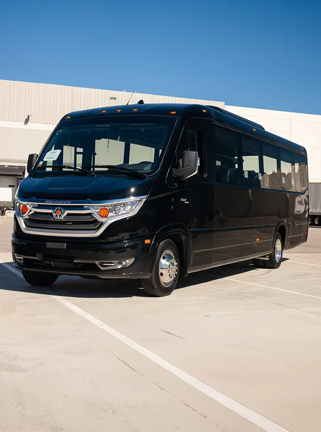 black marcopolo 32 passenger exec bus parked outside in a parking lot
