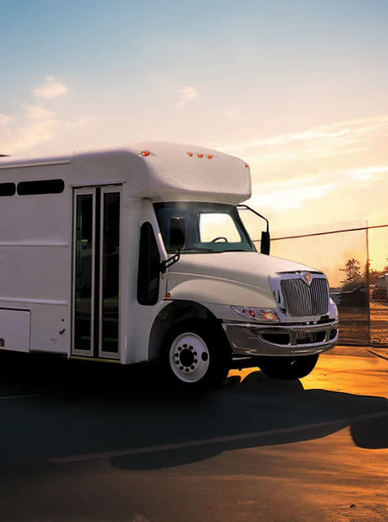 White shuttle bus parked next to a security fence at a prison near Charlotte
