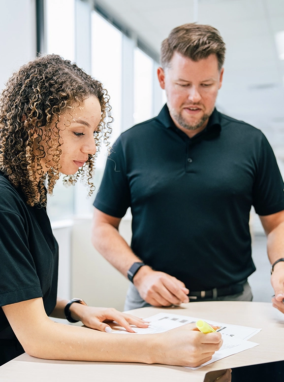 woman and man looking at forms for renting a vehicle in Charlotte